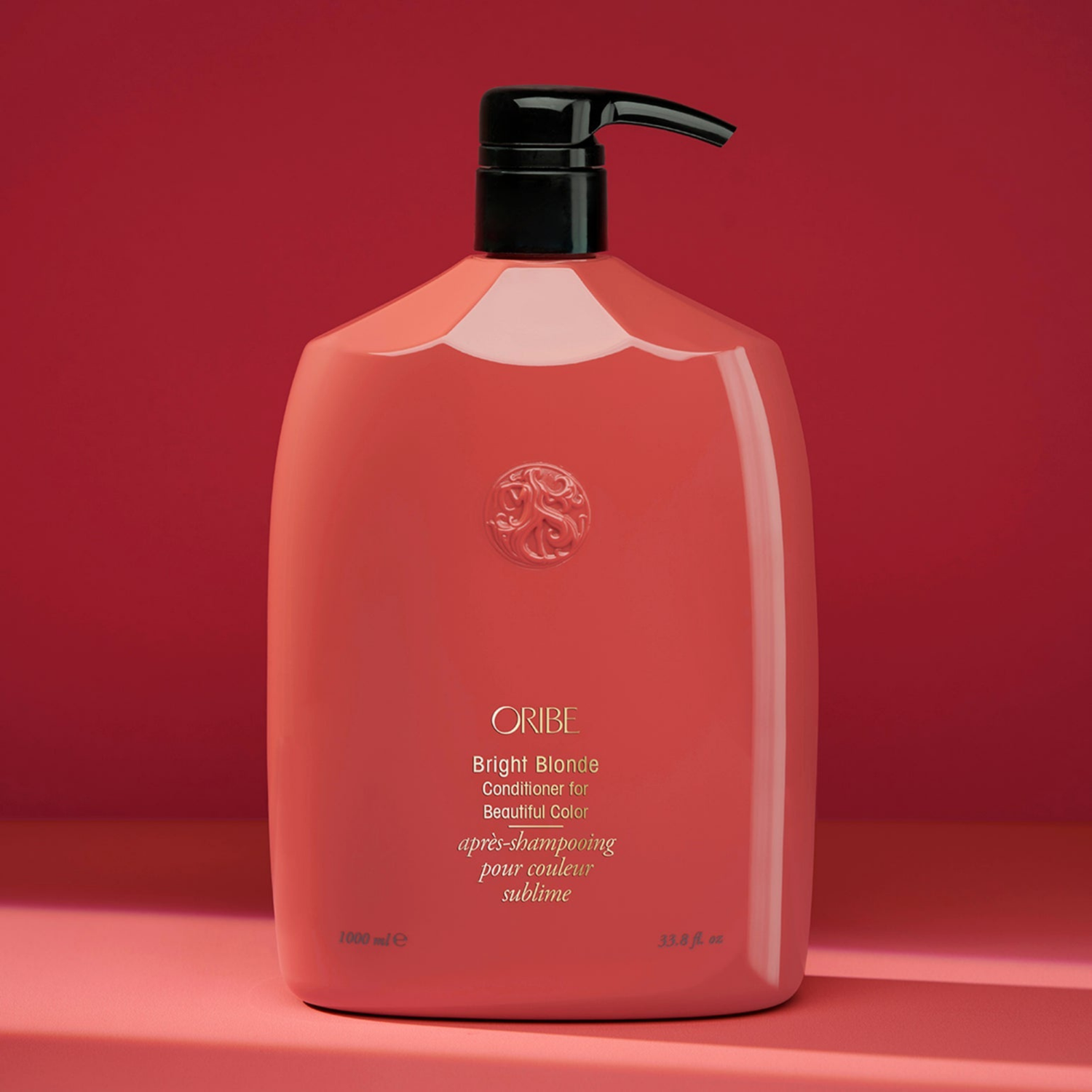 Oribe shampoo bottle on a red background