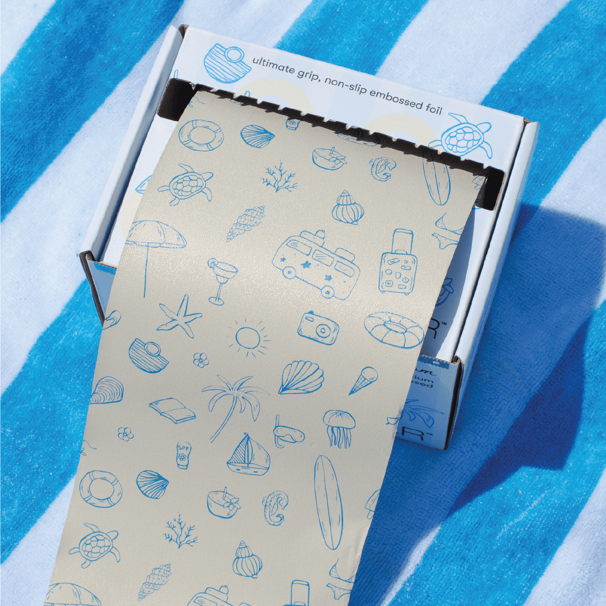 Framar Beach Bum Embossed Roll in  a dispensing box with a blade for convenience
