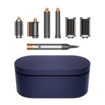 Dyson Airwrap Multi Styler with multiple attachments displayed alongside a blue storage case, showcasing the copper and nickel finishes.